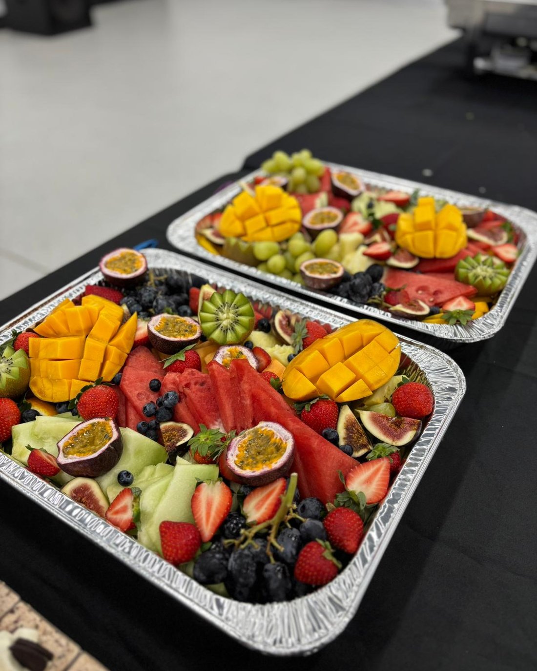 Fresh fruit platters with mango, watermelon, figs and berries