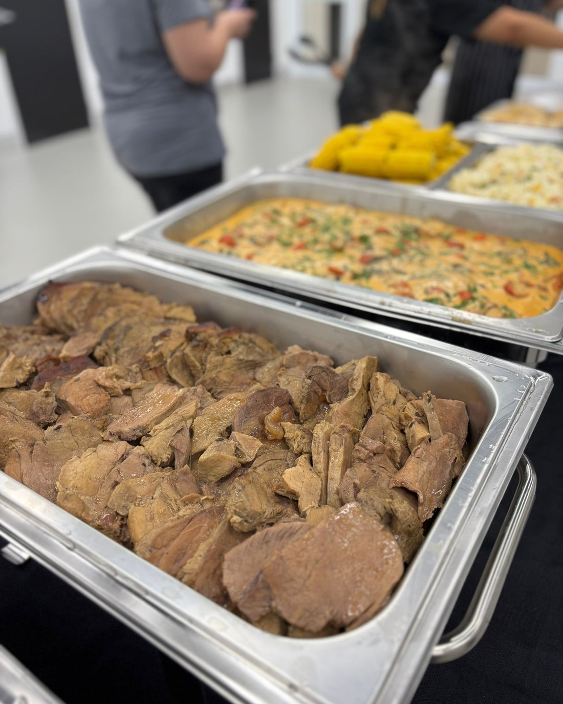 Buffet trays of slow-cooked meat, fried rice and sweetcorn